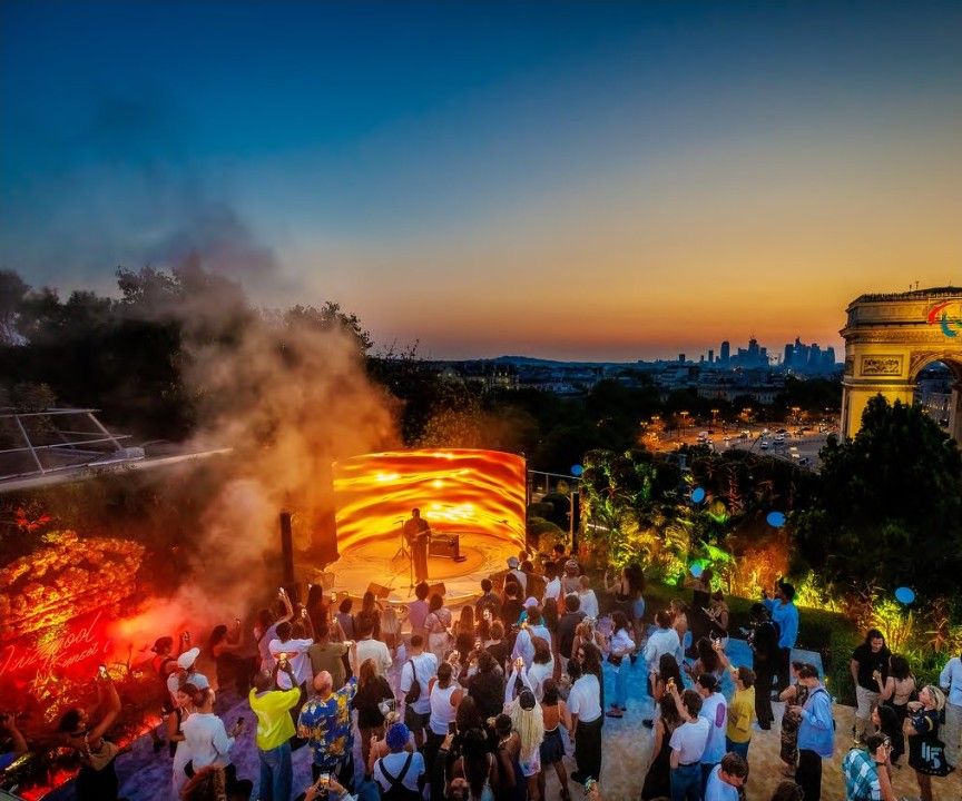 Evening show with smoke and crowd, Paris skyline behind